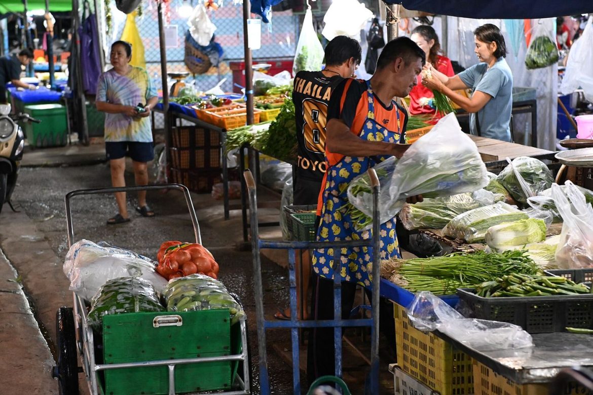 A market stall piled with fresh vegetables