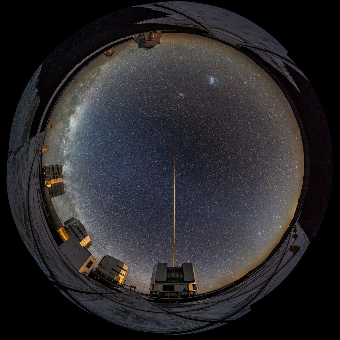telescope silhouetted under a star-filled night sky